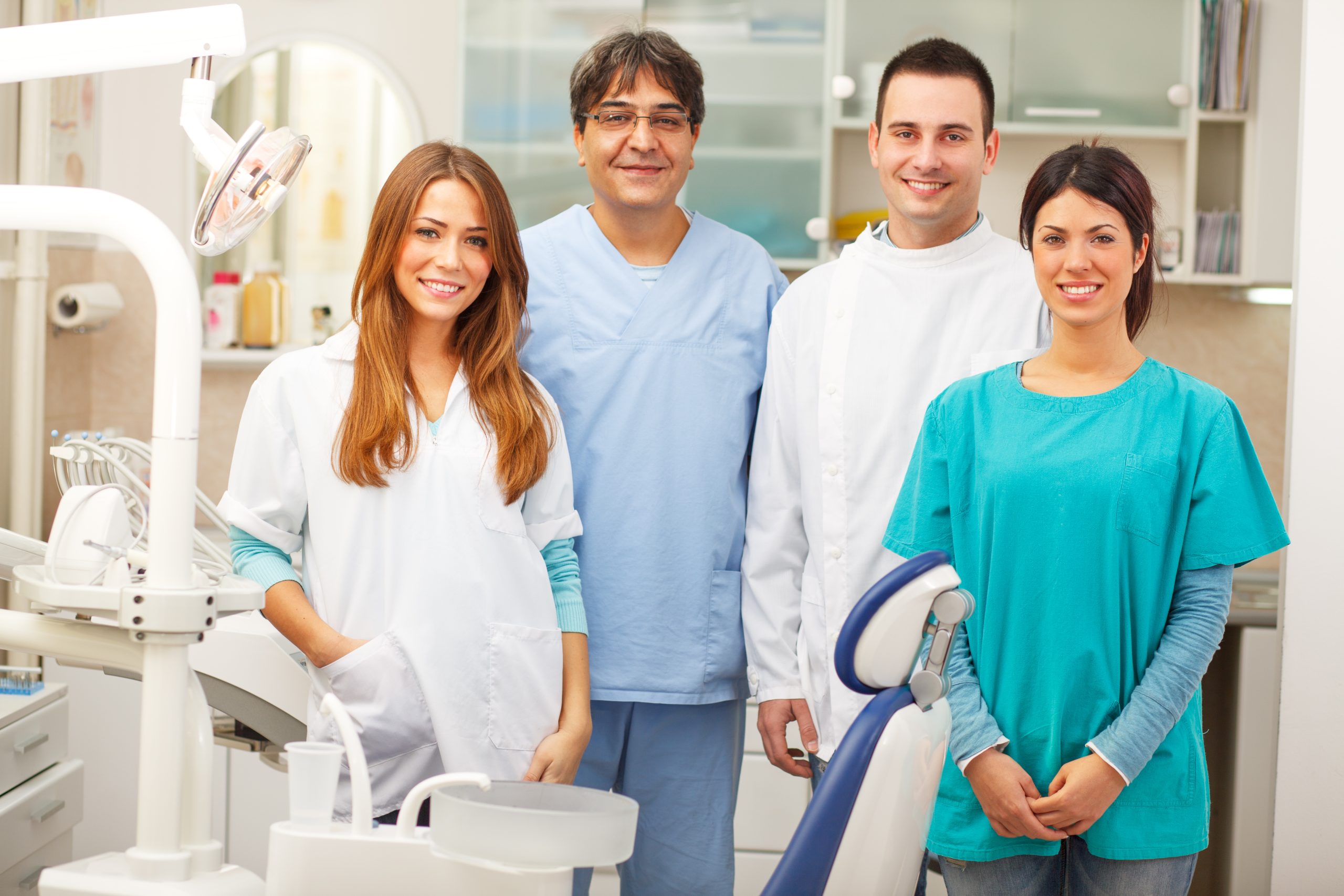 Group,Of,Dentists,Standing,In,Their,Office,And,Looking,At